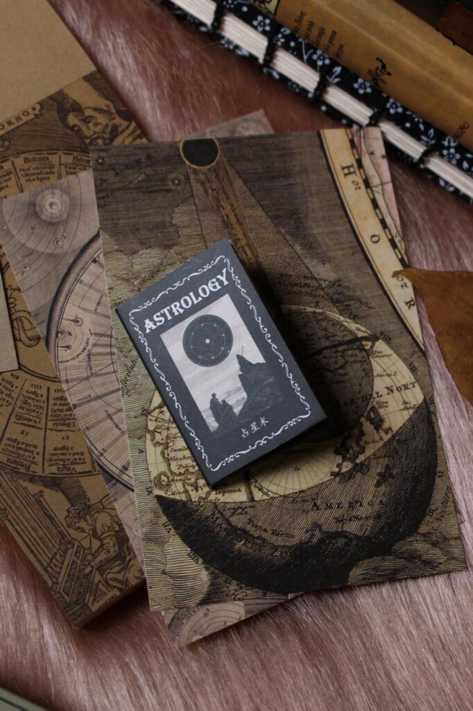 an aesthetic flat lay of junk journaling supplies gathered on top of a handmade journal surrounded by art props vintage papers and dry leaves